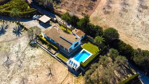 An aerial view of a house with a swimming pool, surrounded by trees and a hilly landscape. - VILLA GABRIEL - RUSTIC STAY (Alcúdia)