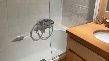 Shower, hair dryer, towels, toilet paper