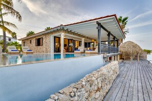 Ein Resort mit Schwimmbad, Naturstein-Fassade und einer Holzterrasse.