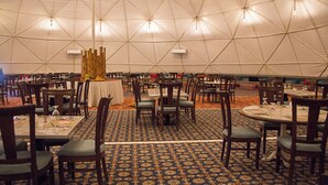 A large tent with multiple tables and chairs arranged for dining. - Desert Season Camp (Wadi Rum)