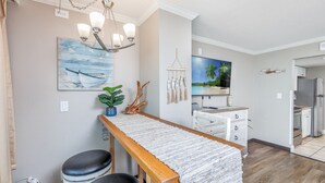A modern kitchen with a wooden countertop, white cabinets, and a built-in oven. - Oceanfront King Suite - Fabulous Views - King Bed - Indoor and Outdoor pools (Myrtle Beach)