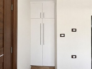 A white wardrobe with two doors and a wooden floor. - White Pyramids inn  (Giza)