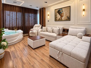 A modern living room with a jacuzzi, sofas, and a wall-mounted artwork. - White Pyramids inn  (Giza)