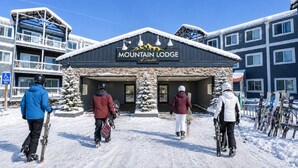 A building labeled 'Mountain Lodge' with a ski lift in the background. - ML365 Slope Side Getaway in Snowshoe Sleeps 6 WiFi (Snowshoe)