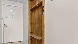 A hallway with a white door and a wooden door with a shelf. - ML365 Slope Side Getaway in Snowshoe Sleeps 6 WiFi (Snowshoe)