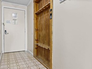 Ein Korridor mit einer weißen Tür und einer Holztür mit Ablage.