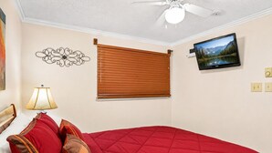 A bedroom with a bed, a wall-mounted TV, a ceiling fan, and a window with blinds. - ML365 Slope Side Getaway in Snowshoe Sleeps 6 WiFi (Snowshoe)