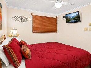 A bedroom with a bed, a wall-mounted TV, a ceiling fan, and a window with blinds. - ML365 Slope Side Getaway in Snowshoe Sleeps 6 WiFi (Snowshoe)