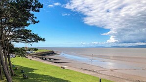 A coastal park with a grassy area, a walking path, and a view of the sea. - The Police Station - UK45642 (Silloth)
