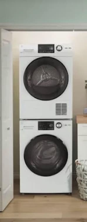 A stacked washer and dryer unit in a laundry room. - Marco Island Retreat, gulf direct canal & dock, stroll to beach, best location… (Marco Island)