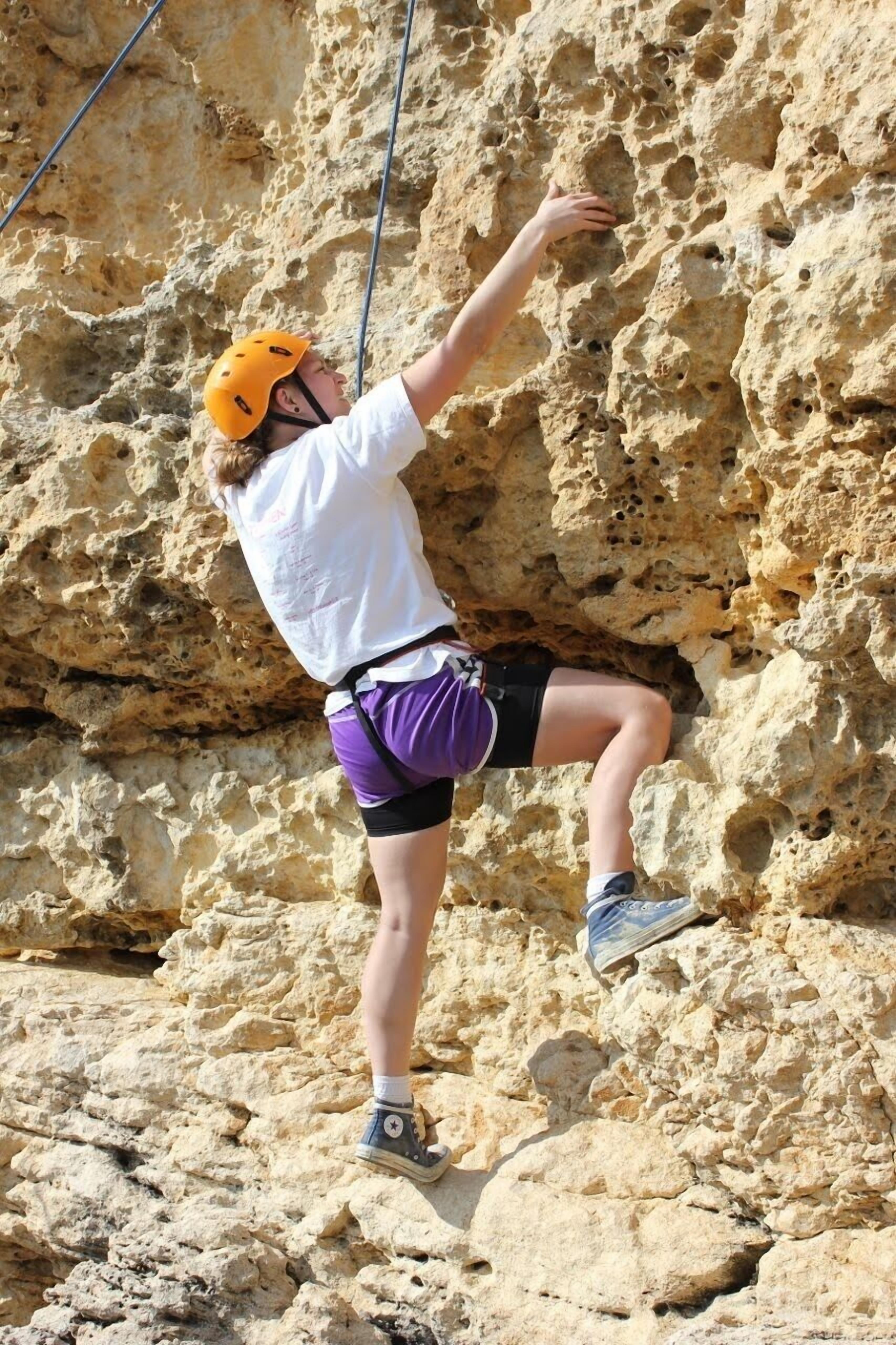 A person climbing a rocky wall.