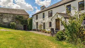 A traditional stone building with a white facade and a tiled roof. - Church House Cottage (Ulpha)