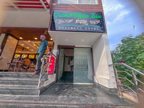 The entrance of Grand Vista Inn Business Hotel with a staircase leading up to the entrance. - Hotel Grand Vista Inn (Bengaluru)