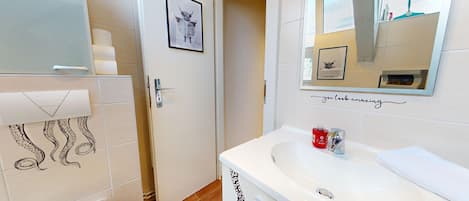 Shower, hair dryer, towels, toilet paper