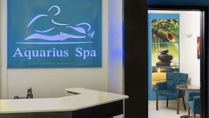A reception area with a sign reading "Aquarius Spa" and a reception desk. - Large Pool/ 1 BR/1Bath  Apt. in Beautiful St. Martin in Simpson Bay! (Simpson Bay)