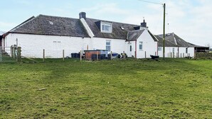 A white building with a sloped roof, a fenced yard, and a utility pole. - Muirston Farmhouse - UK44977 (Cumnock)