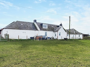 A white building with a sloped roof, a fenced yard, and a utility pole. - Muirston Farmhouse - UK44977 (Cumnock)
