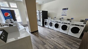 A laundry facility with multiple washing machines, a vending machine, and a Pepsi refrigerator. - Pet Friendly King Studio, Center Village, walk to slopes 446 (Copper Mountain)