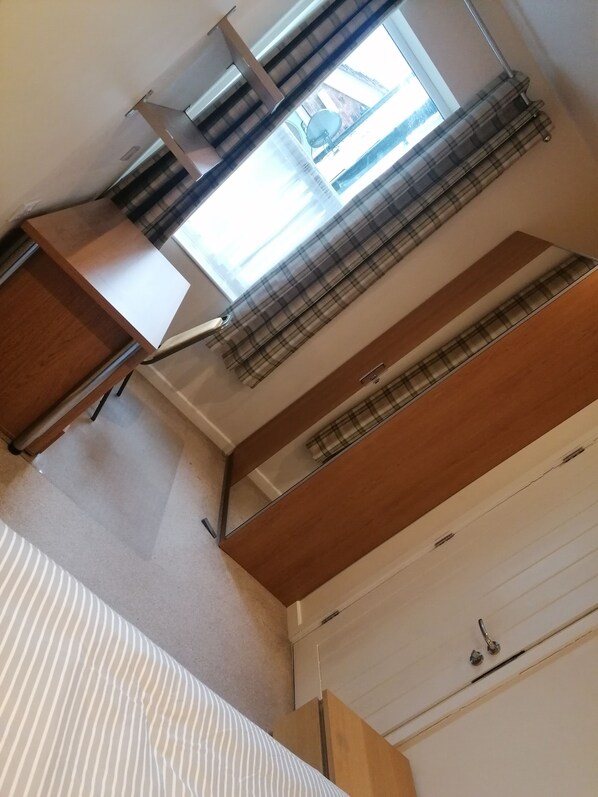 A compact room with a window, a bed, and a small desk. - 92 Seaford Street (Stoke-on-Trent)