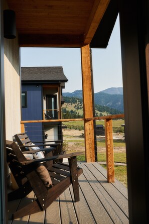 A wooden deck with a view of a mountain landscape. - Aspects Big Sky (Gallatin Gateway)