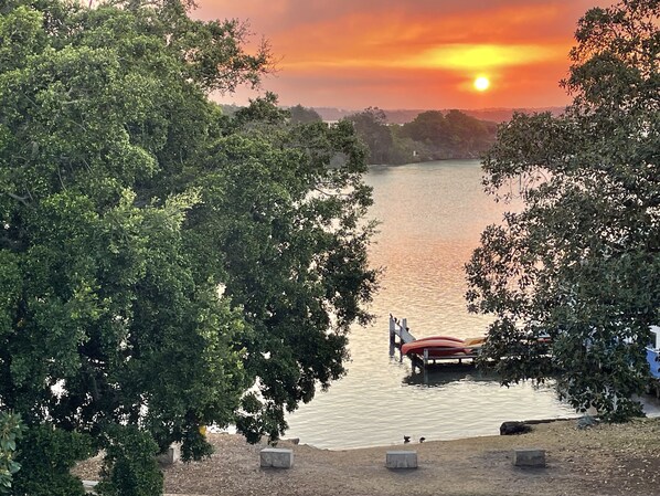 A lakeside view with a dock and a rowboat. - Water views in town centre. Secure parking with lift. (Forster)
