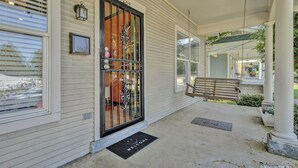 A porch with a bench, a mail sign, and a welcome mat. - Fun & Funky #2 centrally located in Memphis! (Memphis)