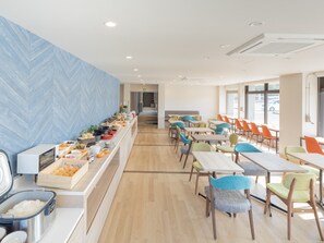 A modern dining area with a buffet, colorful chairs, and a herringbone-patterned wall. - Tabino Hotel EXpress Narita (Narita)