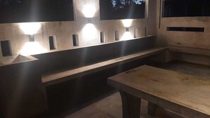 An outdoor seating area with built-in lighting and a bench. -  Cosy villa with style, luxury and great comfort Close to beach and amenities 

 (Negombo)