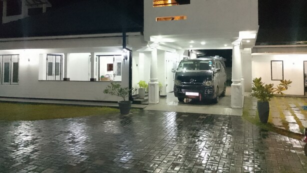 A modern two-story building with a black van parked in front. -  Cosy villa with style, luxury and great comfort Close to beach and amenities 

 (Negombo)