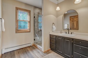 A bathroom with a shower, a sink, and a vanity. - Cascadia (Cascade)