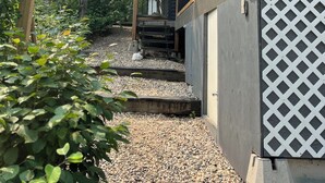 A wooden sign reading "Driftwood Lodge" with a gravel path leading to a building with a balcony. - 4 Season Cabin great for Summer or Winter activities! 
Excellent Green Space (Marean Lake)