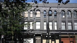 A building with a classical architectural style, featuring arched windows and a symmetrical facade.