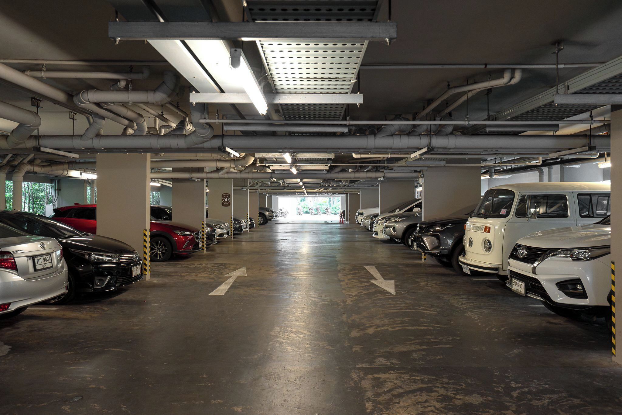 A multi-level parking garage with cars parked on both levels.