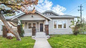 A single-story house with a front porch, brick pillars, and a visible garage door.