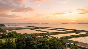 A coastal landscape with multiple water bodies and a sunset. - Ganghwa Hanabi Pension (Incheon)