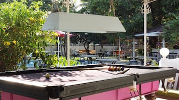 Relax by the pool, where a pool table and comfortable seating invite socializing and leisure activities.