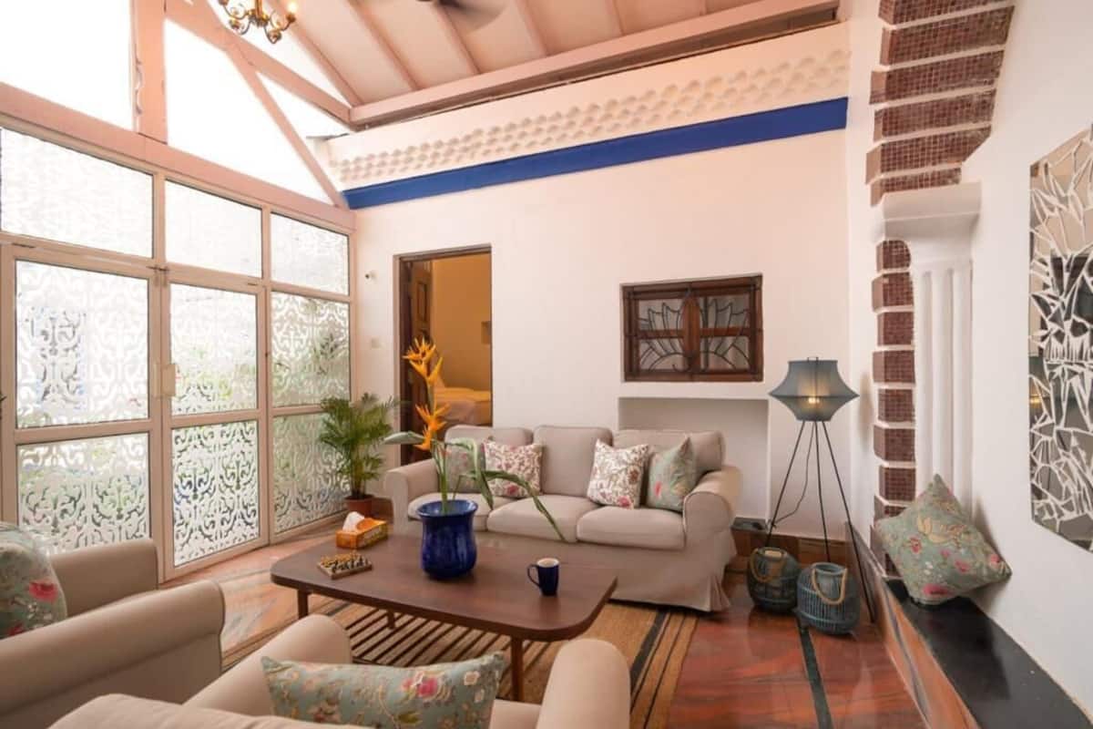A spacious living area with a sofa set, a coffee table, and a floor lamp.