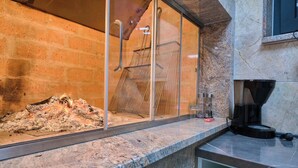 A kitchen with a charcoal grill, a coffee maker, and a brick wall. - Villa My Dream in Kastel Stari (Kastela)