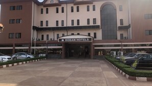 A hotel with a sign reading "ROBAN HOTELS" at the entrance. - Roban Hotels Limited (Enugu)