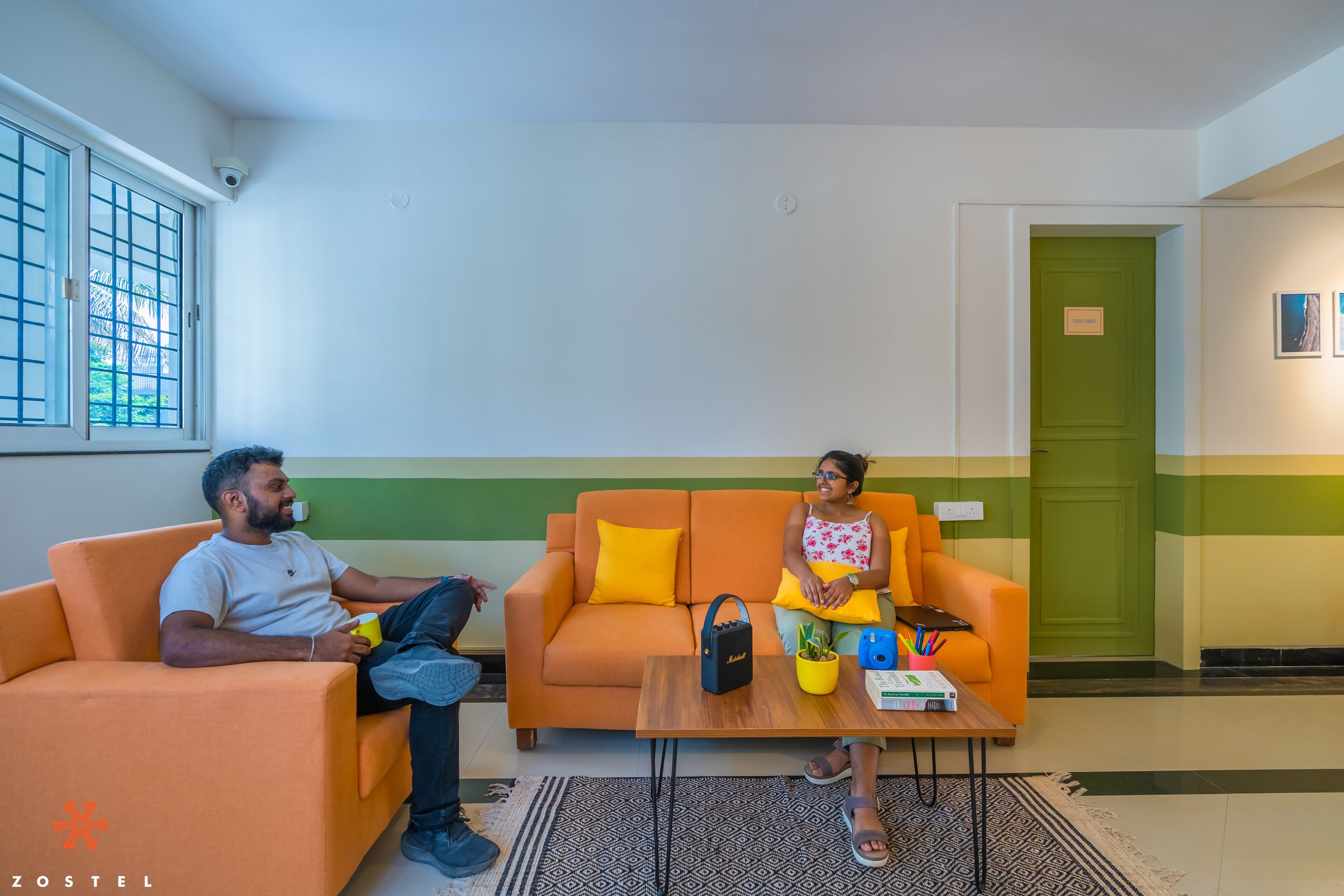 A room with a sofa, a coffee table, and a door.