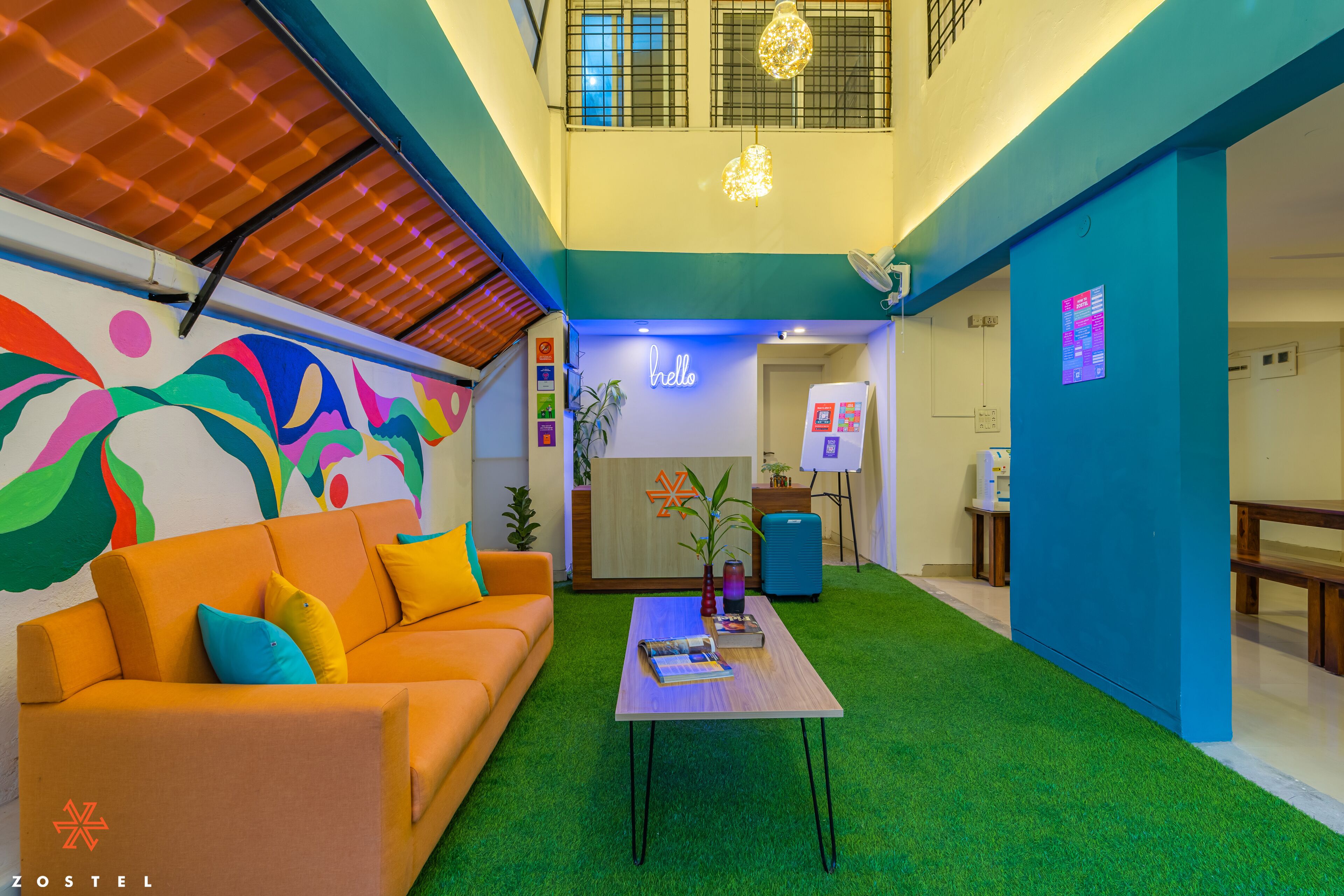 A modern interior with a sofa, a coffee table, and a reception desk.