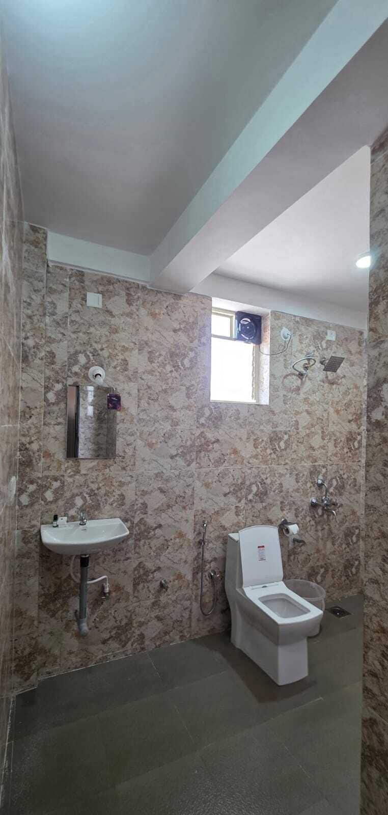 A bathroom with a sink, toilet, and shower.