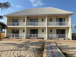 Stunning two-story building with spacious balconies and a flat roof.