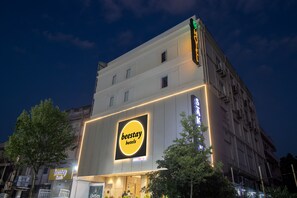 Beestay Hotel features a modern exterior with a prominent sign and flat facade.