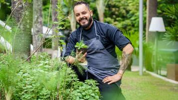 A person in a garden holding a plant.