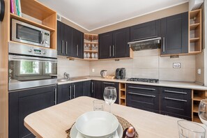 Apartment, 1 Bedroom, Balcony | Private kitchen | Microwave, dishwasher, coffee/tea maker, cookware/dishes/utensils - Ground Floor Apartment by Renters (Poznan)