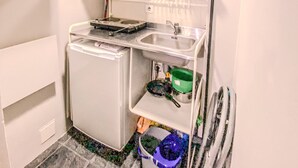 A compact kitchen with a refrigerator, a sink, and a small countertop. - A Great Ramblas and Sea (Barcelona)