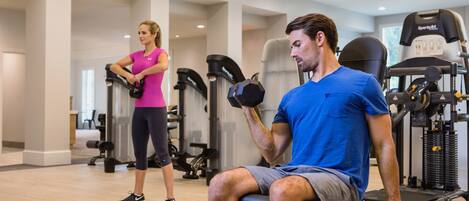 A gym with exercise equipment, including treadmills and weight machines.