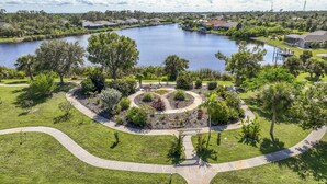 A residential area with a large lake, surrounded by houses and lush greenery.