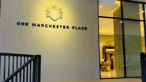 A modern building entrance with a sign reading "ONE MANCHESTER PLACE". - Condo by the Beach OMP Mactan Int'l Airport, 2 bedrooms/2 baths sleeps 7 guests (Lapu-Lapu City)
